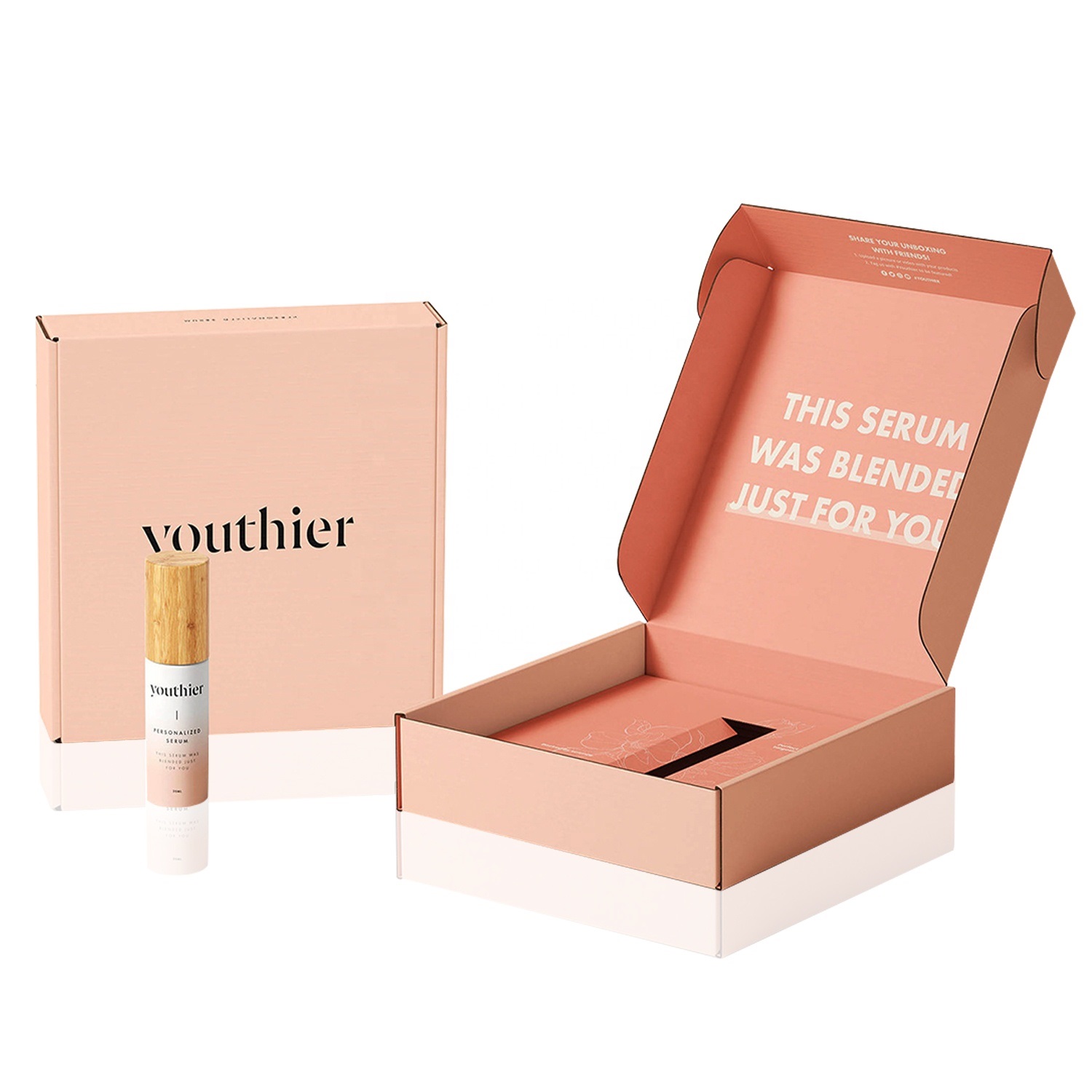 Serum bottle beside a peach printed mailer with a fitted paper insert