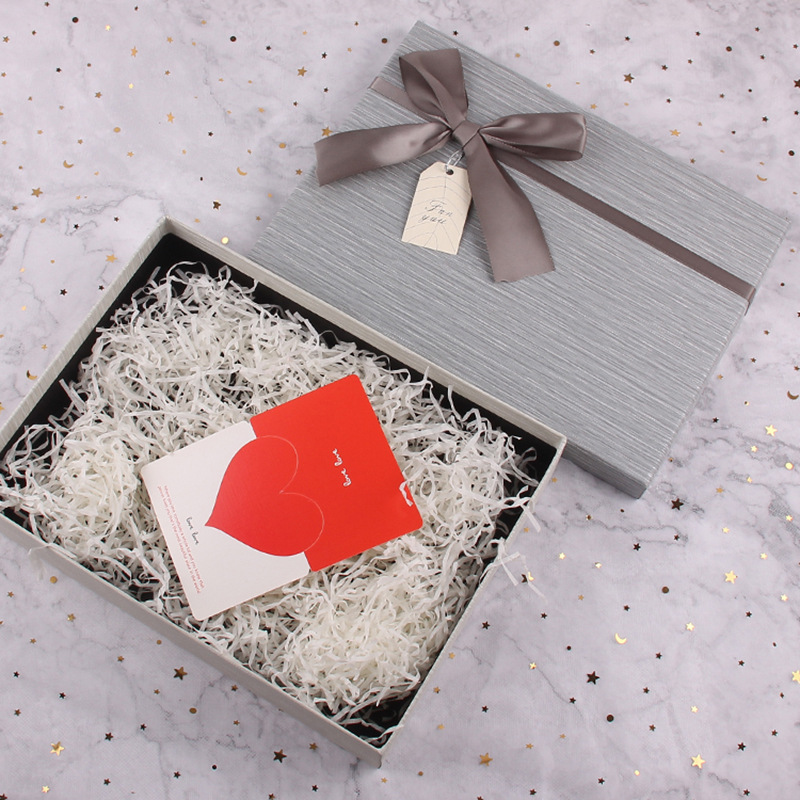 1. Custom packaging accessories displayed with tissue paper, ribbons, and hang tags