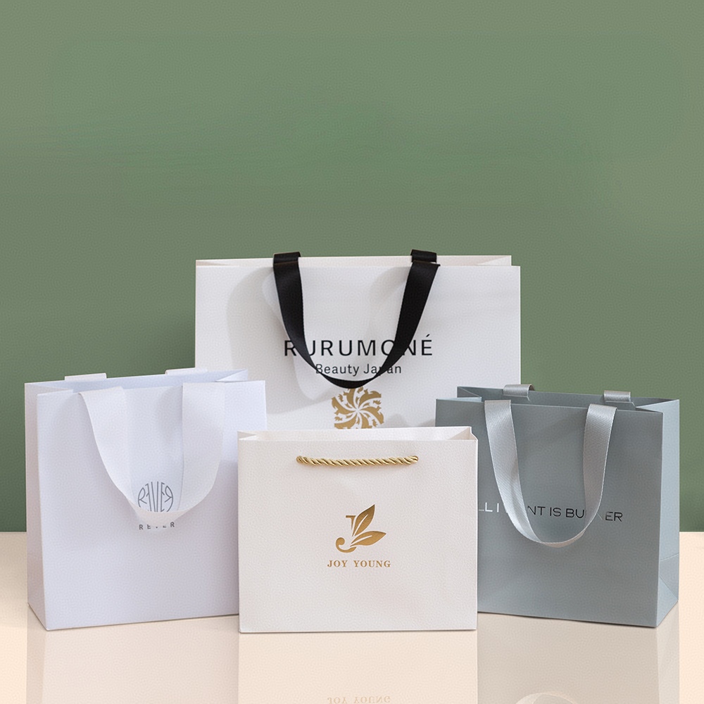 Luxury custom paper bags with logo and ribbon handles for retail packaging